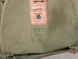 a bag that is sitting on the floor with a tag on it