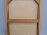 an empty picture frame with a wooden frame on top of it