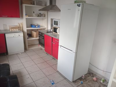 a kitchen with a refrigerator, stove, microwave, and a refrigerator freezer