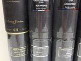 several different types of perfumes are lined up on a shelf