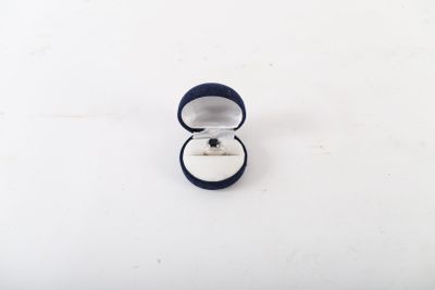 a ring in a ring box on a white surface