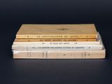 three books stacked on top of each other on a table