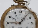 a small gold pocket watch with a chain around it