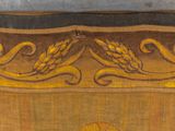 a painting of wheat on the side of a wooden chest