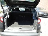 the back of a car with its trunk open in a parking lot