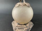 an image of a white glass lamp with a bird on it