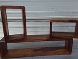 a wooden shelf with a mirror on top of it