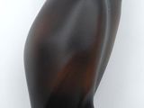 sculpture of an owl on a black base on a white background