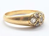 a close up of a gold ring with diamonds on it
