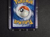 pokemon trading card in a plastic case on a black surface