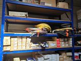 a blue shelving with lots of boxes and supplies on it