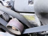 a close up of a car engine with a belt