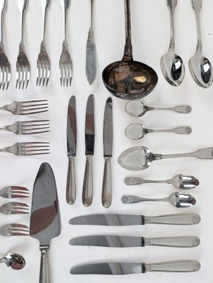 a lot of silver spoons and forks on the table