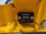 a digital clock on the back of a yellow vehicle