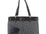 a black and white handbag with a pocket on the front