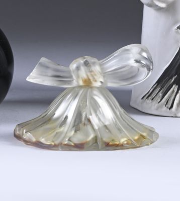 a glass angel figurine sitting next to a black and white vase