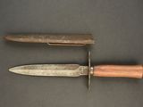 two knives that are laying next to each other on a table