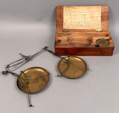 an old brass plate with a pair of scissors and a wooden box