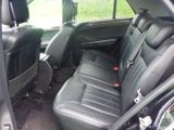 a picture of the inside of a car with black leather seats