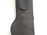 a guitar case sitting on the floor next to a wall