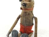 a teddy bear that is sitting on the ground
