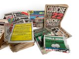 several newspapers are stacked on top of each other on a white surface