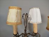 two lamps that are on a table with a lamp shade