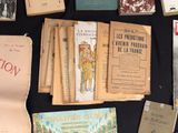 several old books are on a table with a black table cloth
