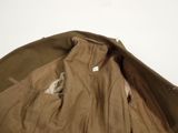 the jacket is brown and has a white label on it