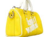 a yellow handbag with a white handle on a white background