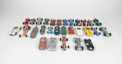 a group of toy cars are lined up on a white surface