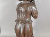 a statue of a woman holding a cell phone to her ear