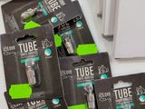 four tubes of tube are sitting on a table next to a red bowl
