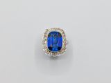 a close up of a ring with a blue stone in it