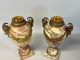 two vases with handles and handles are sitting next to a coin