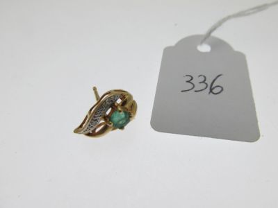an image of a gold ring with a green stone on it and a price tag