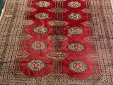 an oriental rug with a red and brown design on it