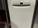 a white dishwasher sitting in the middle of a kitchen