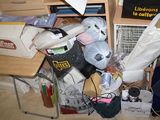 a pile of clutter on the floor in a cluttered room