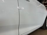 a picture of a white car with a sticker on it