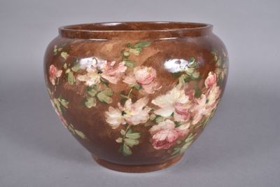 a brown vase with pink and white flowers on it