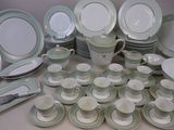 many different types of plates and cups on the table