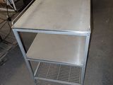 a metal table with a shelf on top of it