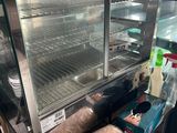 a glass display case with some food inside of it