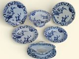 six pieces of blue and white dinnerware on a white surface