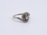 a close up of a silver ring with diamonds on a white background