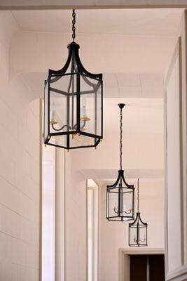 two lanterns hanging from the ceiling in a hallway
