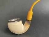 a pipe with a yellow handle sitting on top of a table