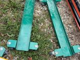 several pieces of metal are laying on the ground next to a skateboard