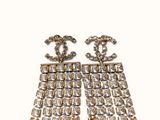 a pair of chandelier earrings with crystals and red beads